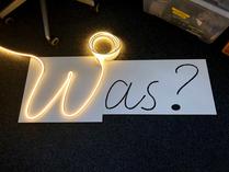 Pleasant surprise: The LED strip did fit perfectly into the cutout left over from the prototype (for this photo the strip had been powered temporarily, just for the effect). To avoid the very tight bend at the center of the “W” I eventually used two distinct strip segments, one for each half of the letter.