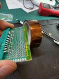 A strip of Kapton tape makes sure the bottom tabs of the connectors will be insulated from the board.